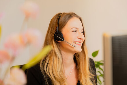 Junge lächelnde Frau mit Headset
